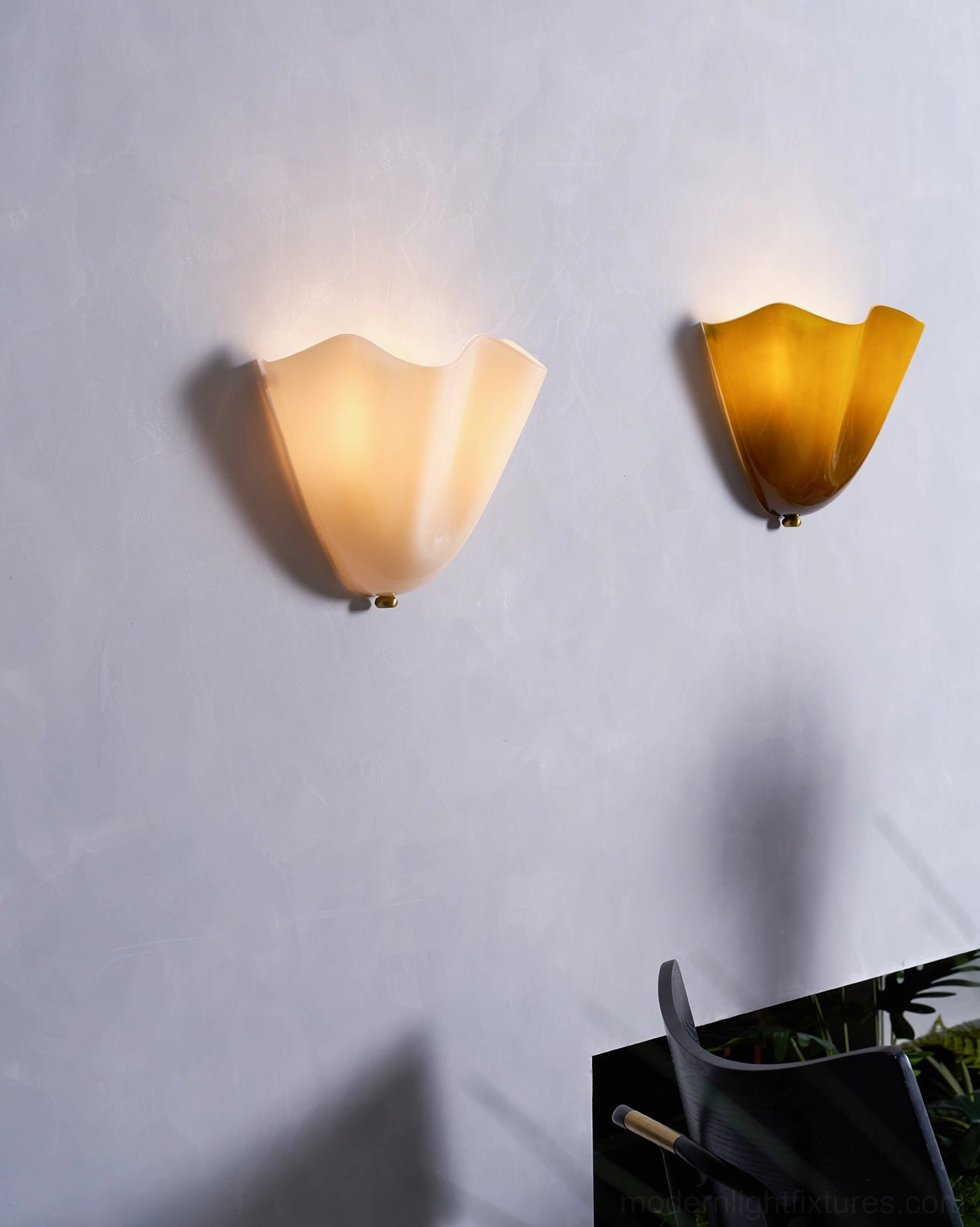 Vera beige white glass wall sconce showing neutral light quality in contemporary bedroom setting