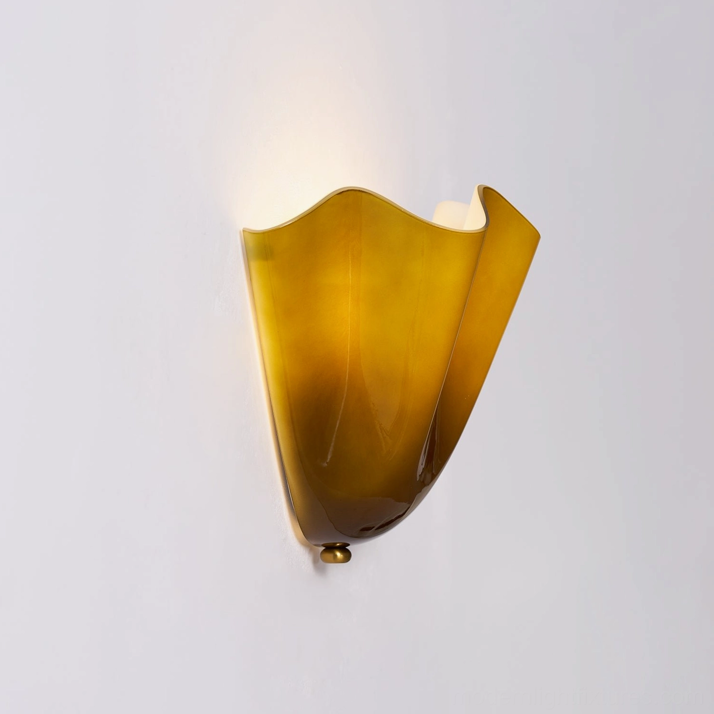 Vera brown glass wall sconce providing warm caramel tone illumination in mid-century interior style