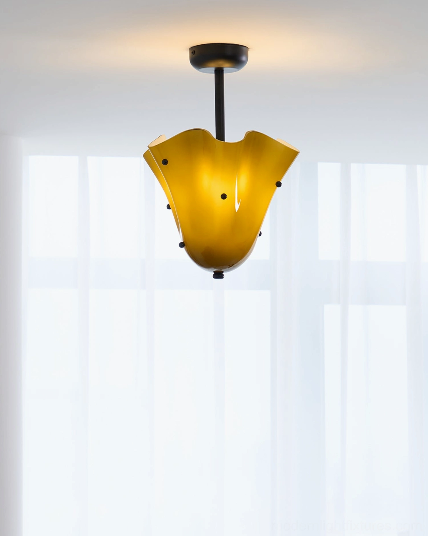 Illuminated vera ceiling light with ruffled shade and warm glow in modern bedroom