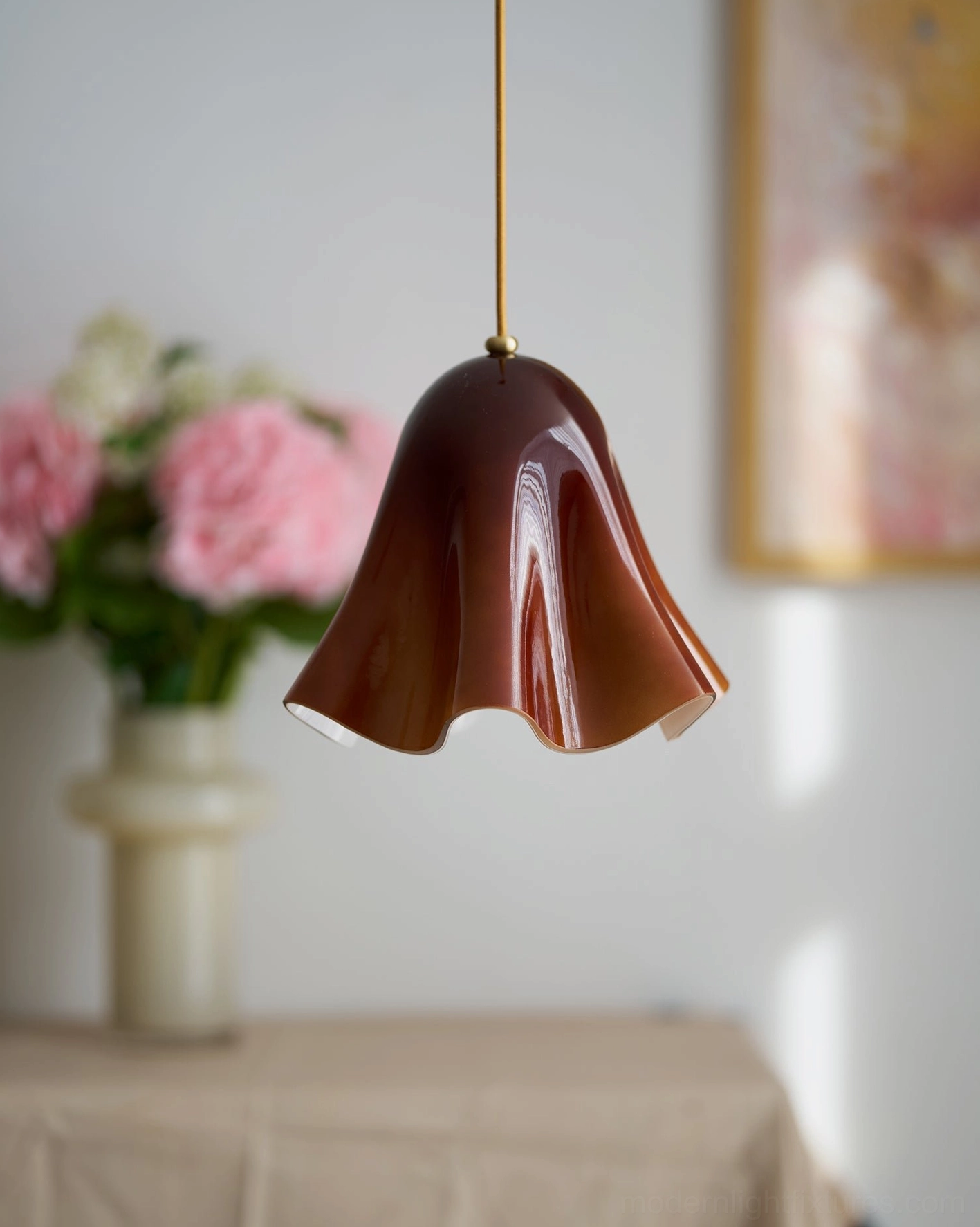 Vera colored glass pendant light in mid-century modern interior setting with brass hardware