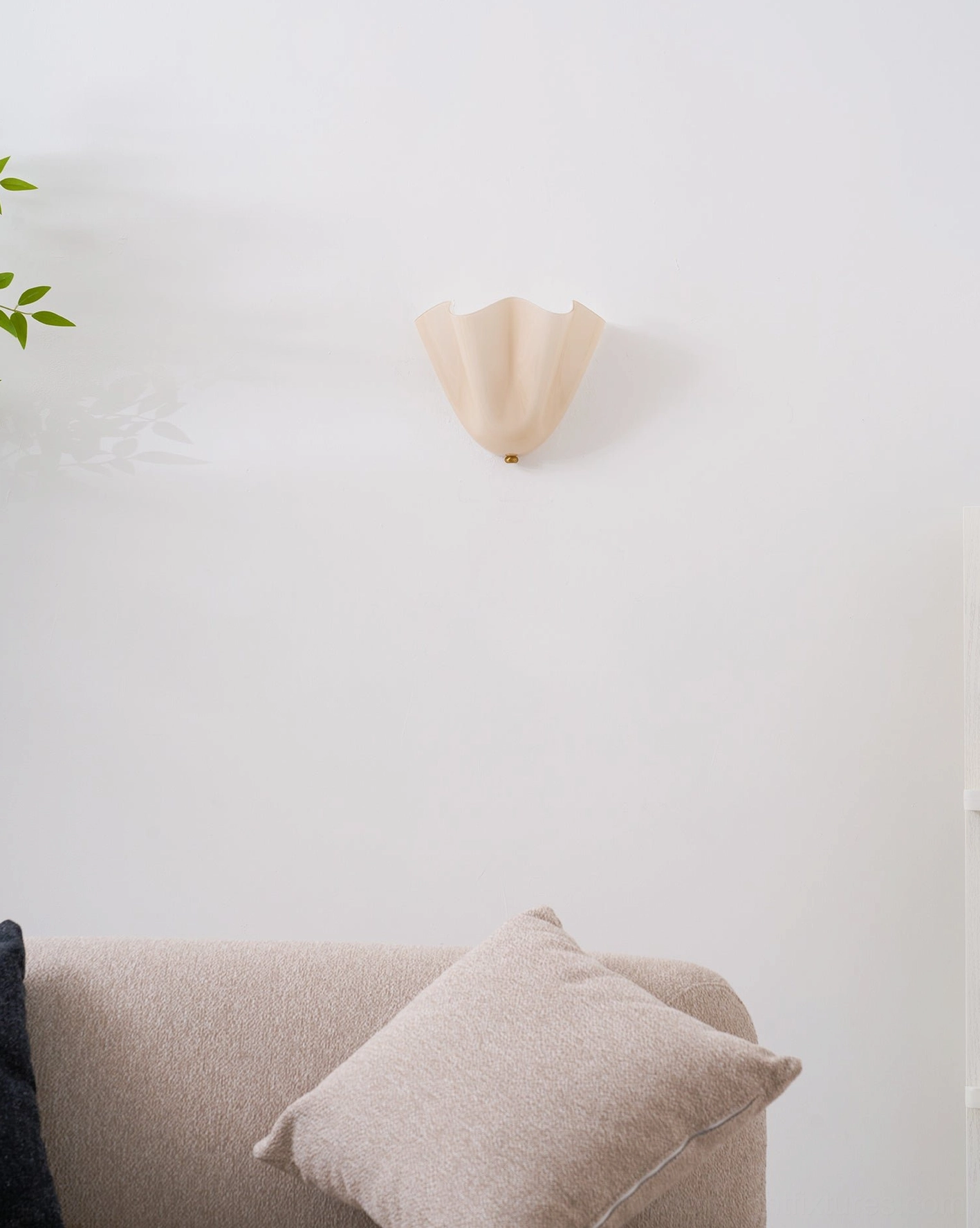Vera green glass wall sconce installed in mid-century modern bedroom with period-appropriate furnishings