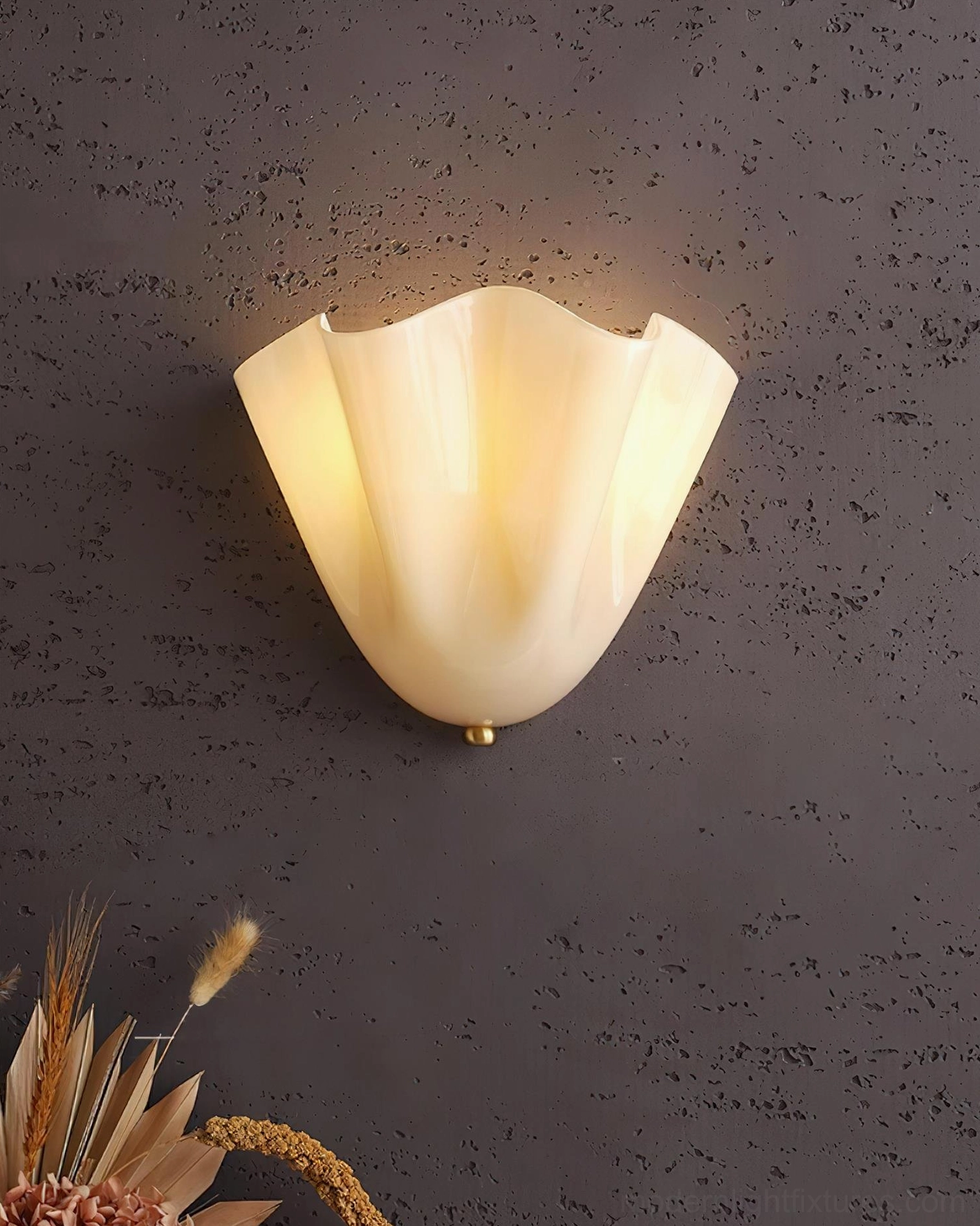 Vera green glass wall sconce creating rich jewel-tone ambient light in sophisticated living interior