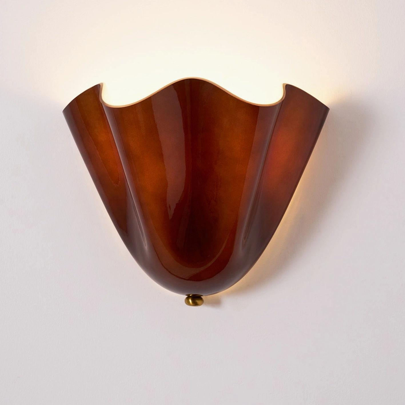 Vera green glass wall sconce installed in sophisticated contemporary interior with modern furnishings