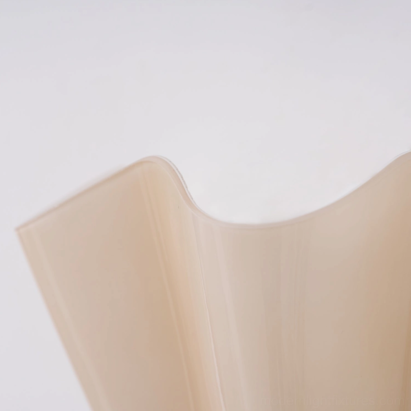 Vera hand-blown glass wall sconce showing craftsmanship detail and subtle color tone variation
