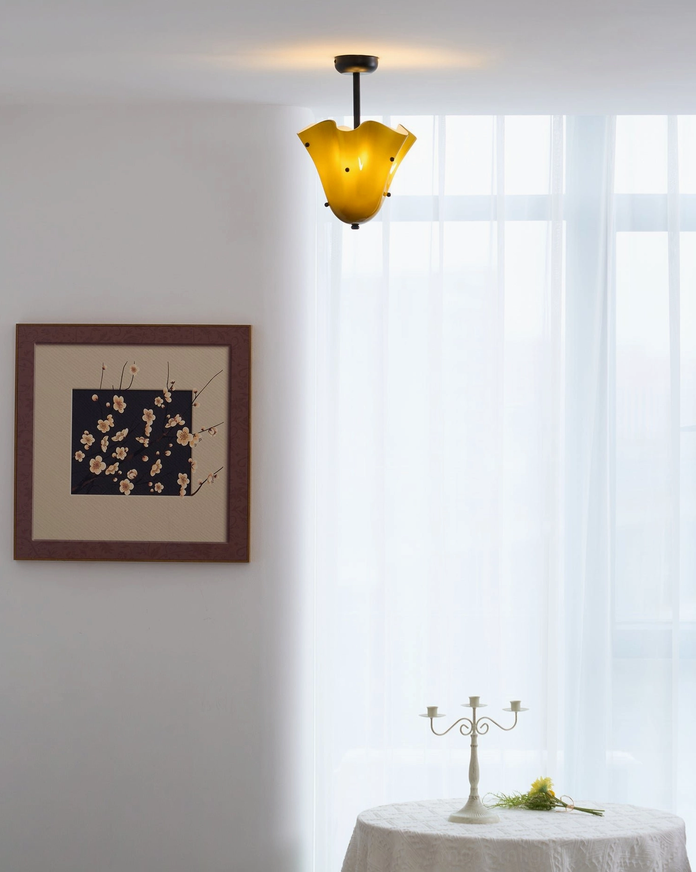 Vera ceiling light artistic detail showing hand-shaped glass and decorative metal elements