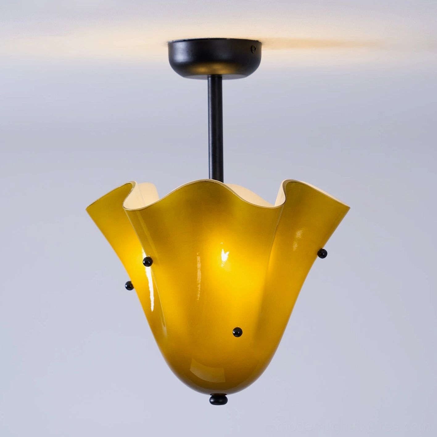 Vera modern sculptural ceiling fixture with organic flowing glass form and metal hardware