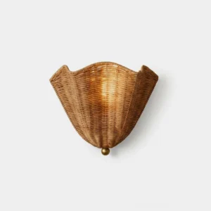 Vera rattan wall sconce front view - hand-woven natural rattan shade with brass base, sculptural boho design