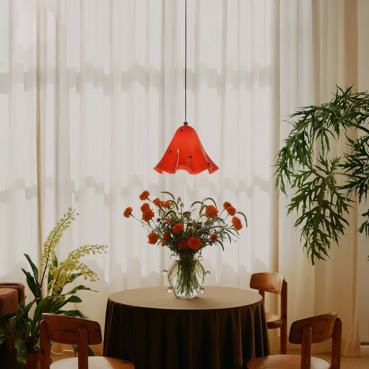 Red ruffled bell-shaped Vera glass pendant light hanging in modern dining nook at eye level