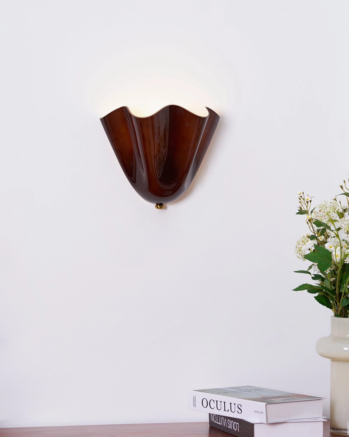 Vera hand-blown glass wall sconce showing interior glass detail and translucent light emission quality