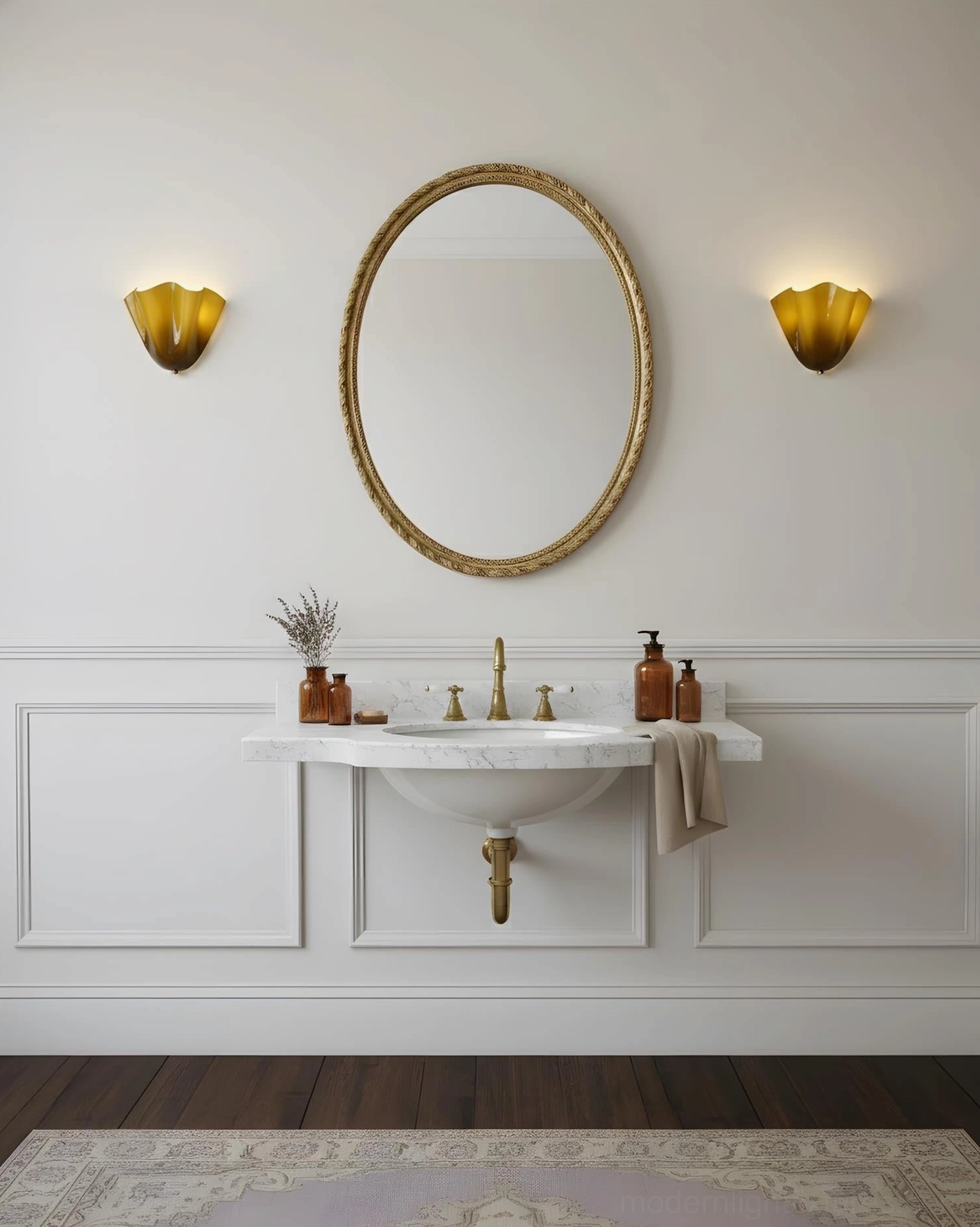 Double Vera amber wall sconces flanking round gold mirror in minimalist white paneled bathroom vanity area