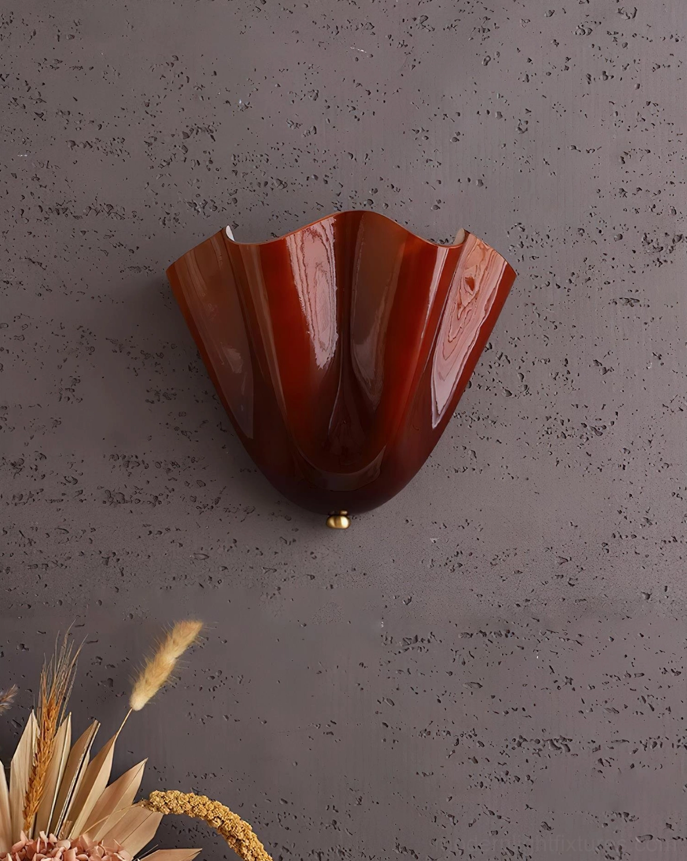Vera wall sconce creating warm pool of light on interior wall for ambient bathroom or bedroom lighting