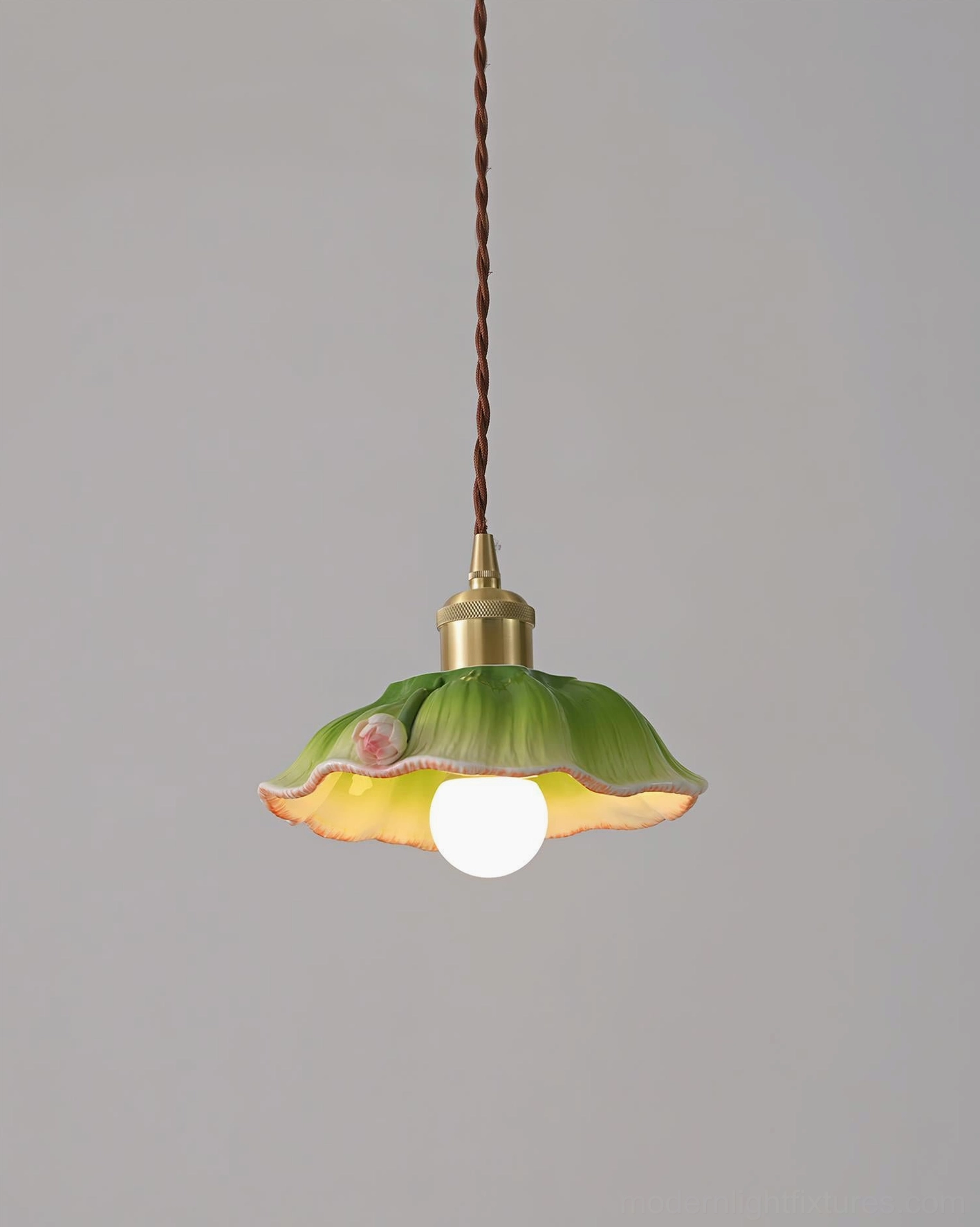 Verdant lotus pendant lamp distant frontal view with compact ruffled ceramic shade and classic brass metal fixture