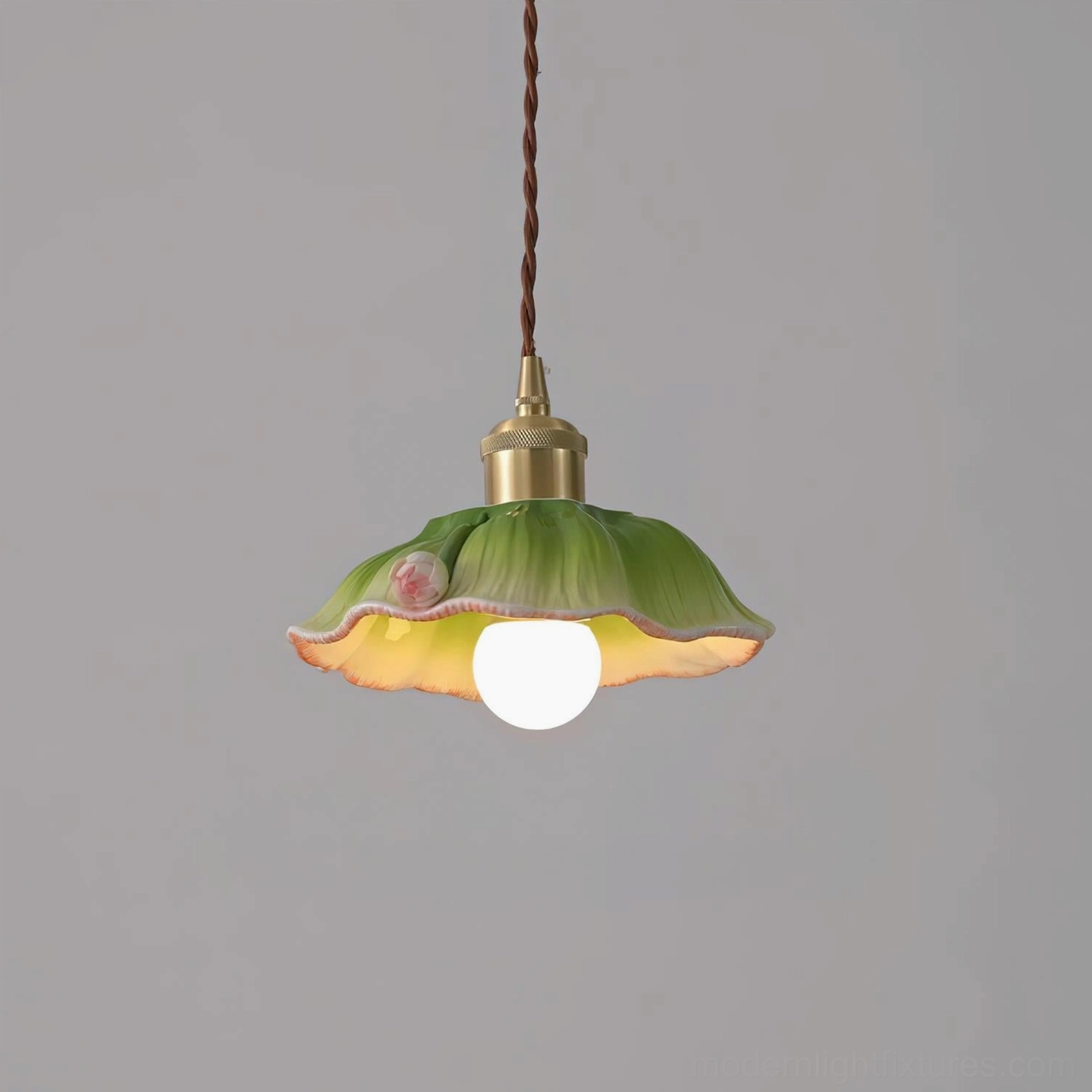 Verdant lotus pendant lamp frontal close-up featuring green hand-painted ceramic shade with pink flower accent and twisted brown power cord