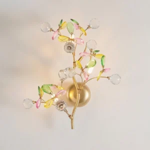 Illuminated Verdelle wall sconce with glowing G4 bulbs casting sparkling light through colored glass leaves and crystal balls