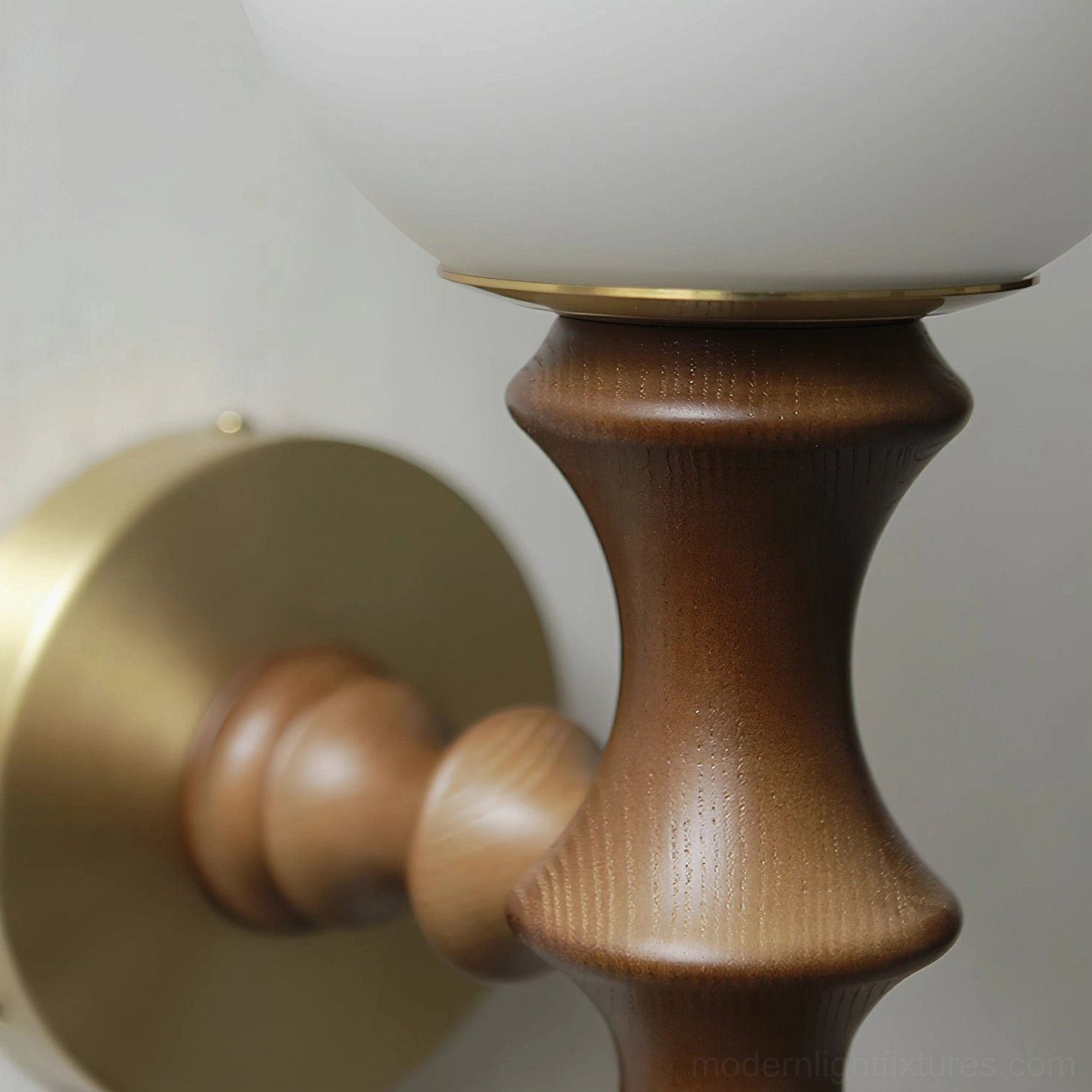 Close-up detail of Vero wall sconce showing hand-turned wood grain and brass trim between frosted glass and wooden arm
