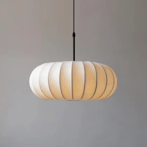 Large Verona pendant lamp three-quarter angle in grey minimalist interior, warm beige fabric shade with matte black hardware