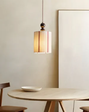 Verticalis pendant lamp glowing softly above minimalist dining table, warm ambient lighting in contemporary dining space
