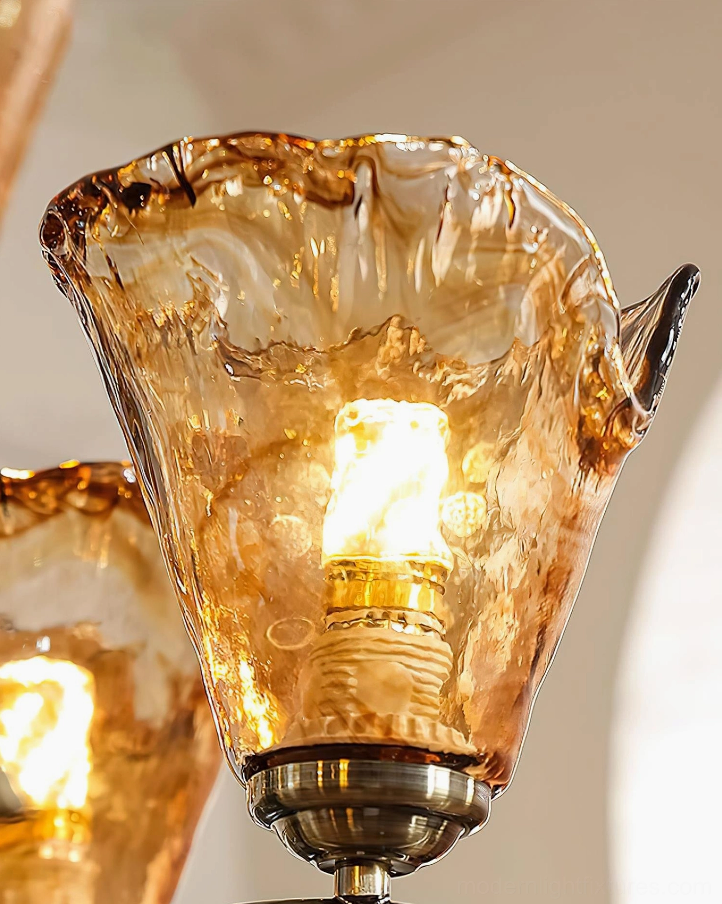 Vetraio chandelier artistic lighting effect, amber glass shades illuminated showing warm golden glow and glass texture quality