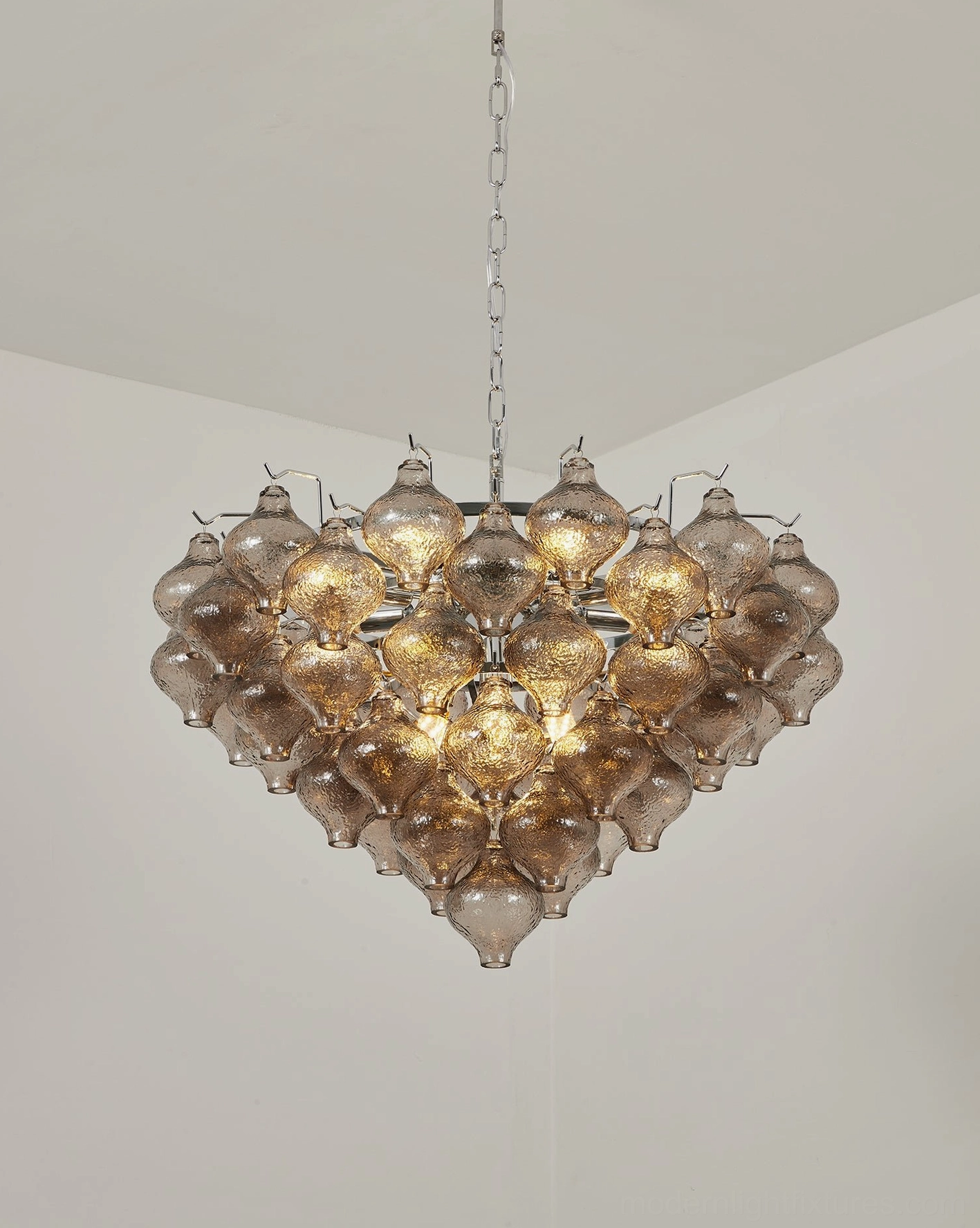 Vetrina hand-textured glass drops close-up showing seeded surface texture and light diffusion characteristic of mid-century glasswork
