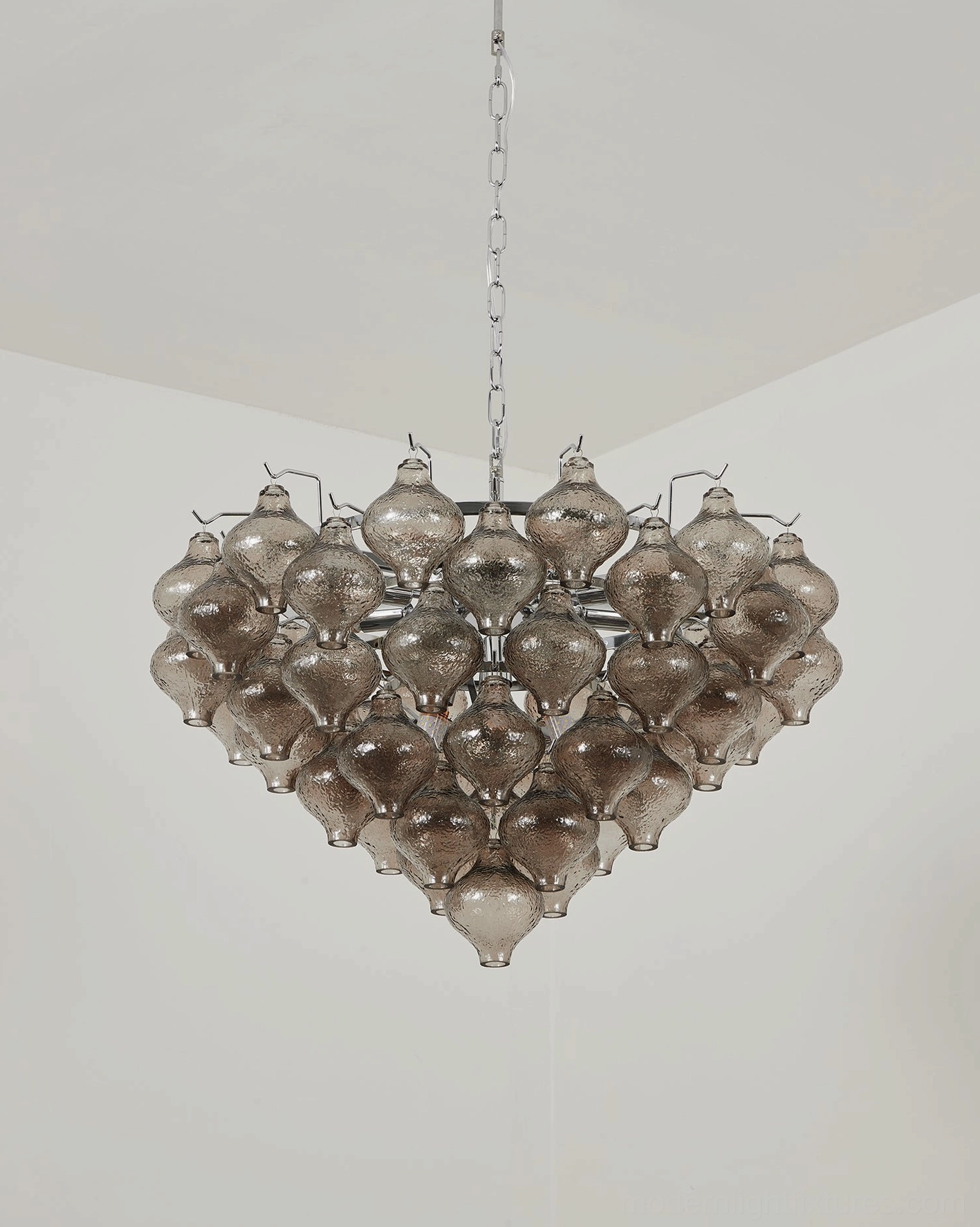 Vetrina tiered tulip chandelier in double-height foyer space with brass metal hardware creating dramatic vertical focal point