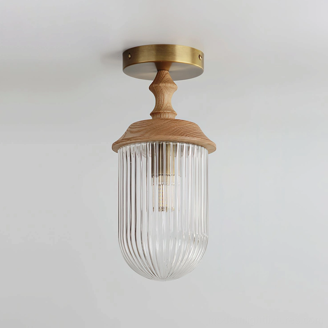 Veyra ceiling light fixture with clear ribbed glass and light wood detail, brass mounting hardware, studio perspective