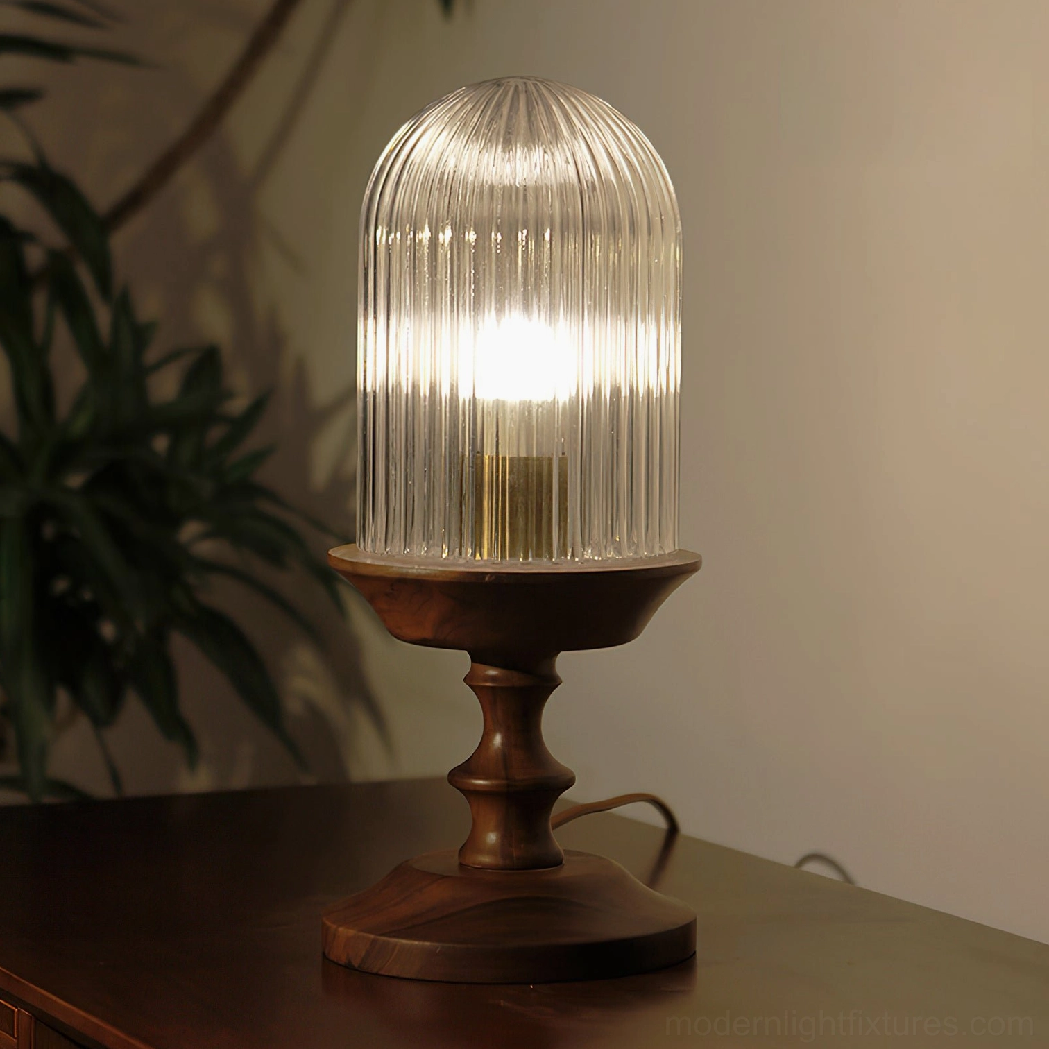 Mid-century modern ribbed glass table lamp with brass socket lit bulb wooden side table interior