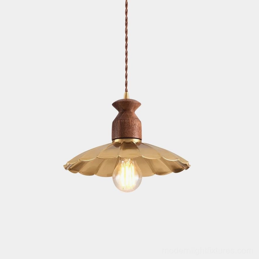 Viana brass petal pendant light with walnut wood accents, front studio view on white backdrop, showing scalloped shade design