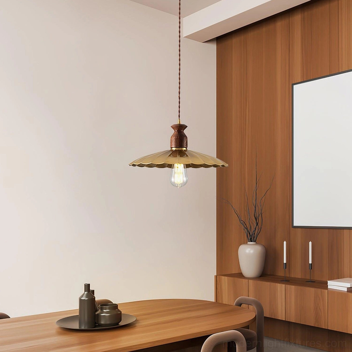 Viana pendant light three-quarter view in warm dining room, brass shade with exposed incandescent bulb, wood-paneled walls