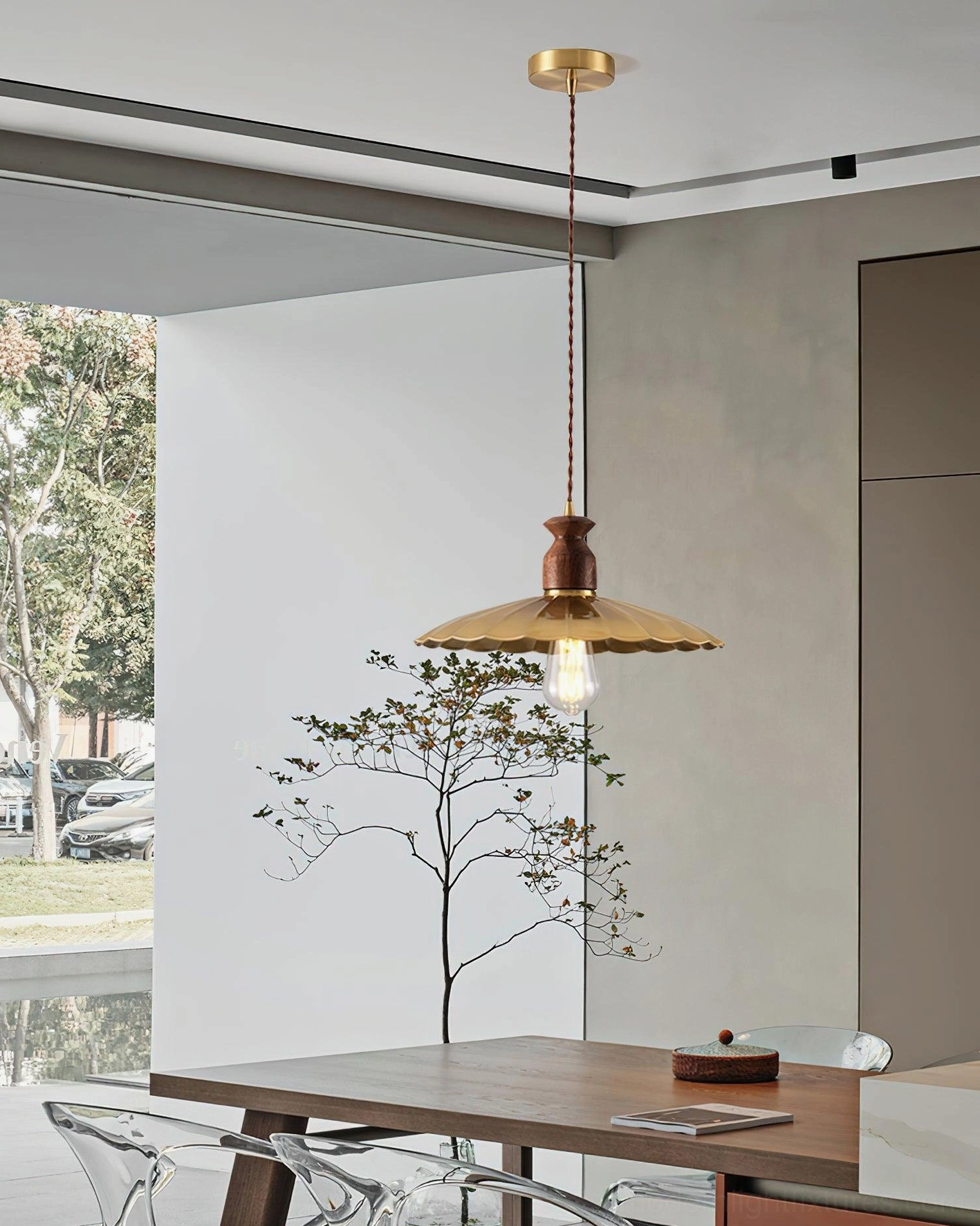 Viana scalloped pendant light elevated side view in open-concept dining space with minimalist clear acrylic chairs