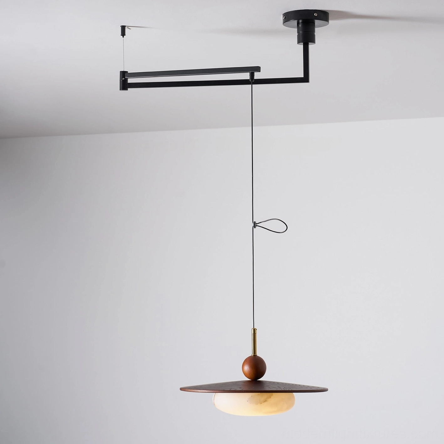 Swing arm pendant light fixture detail showing diffuser quality glass craftsmanship and mounting