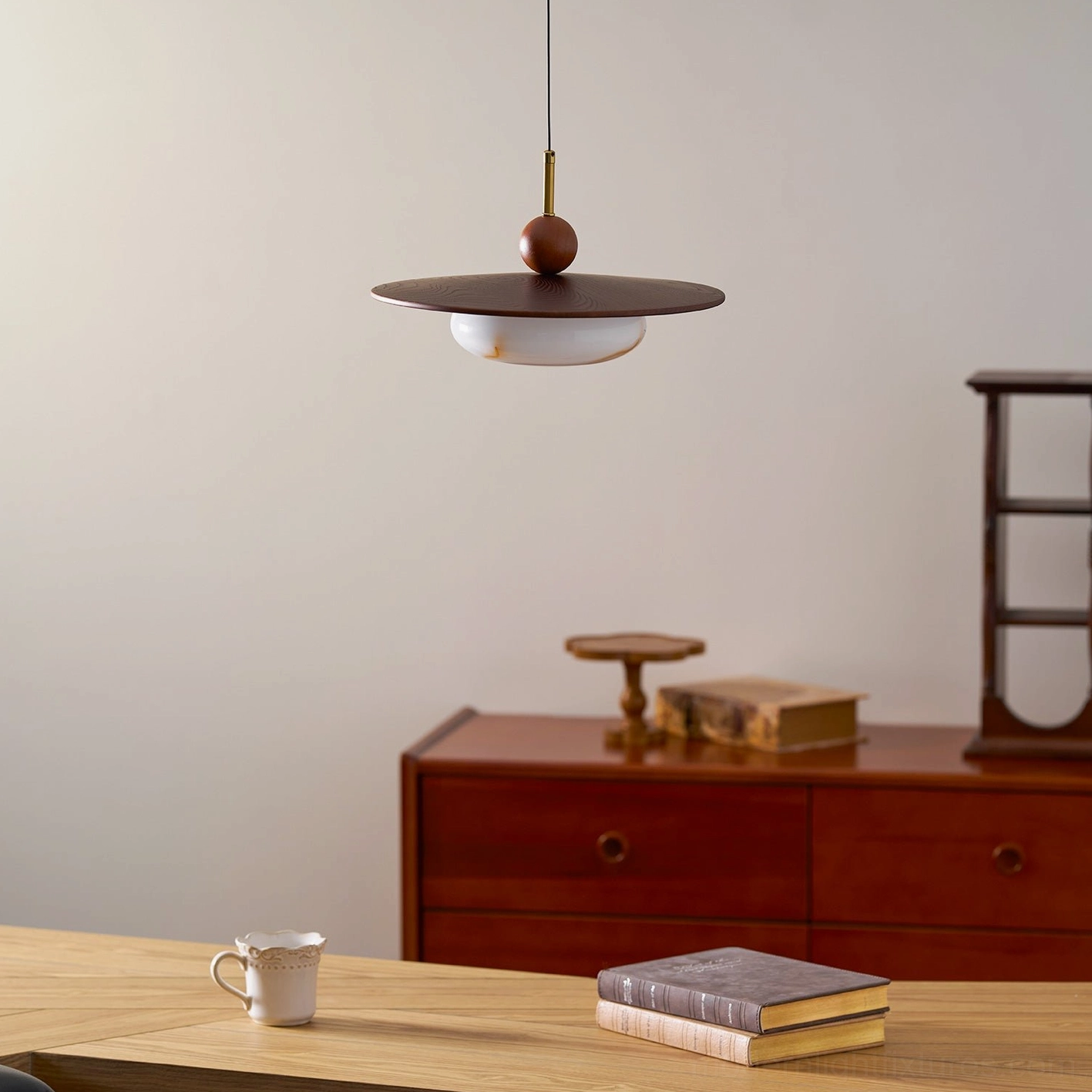 Contemporary swing arm pendant fixture installed dining area with adjustable arm positioned for direct lighting