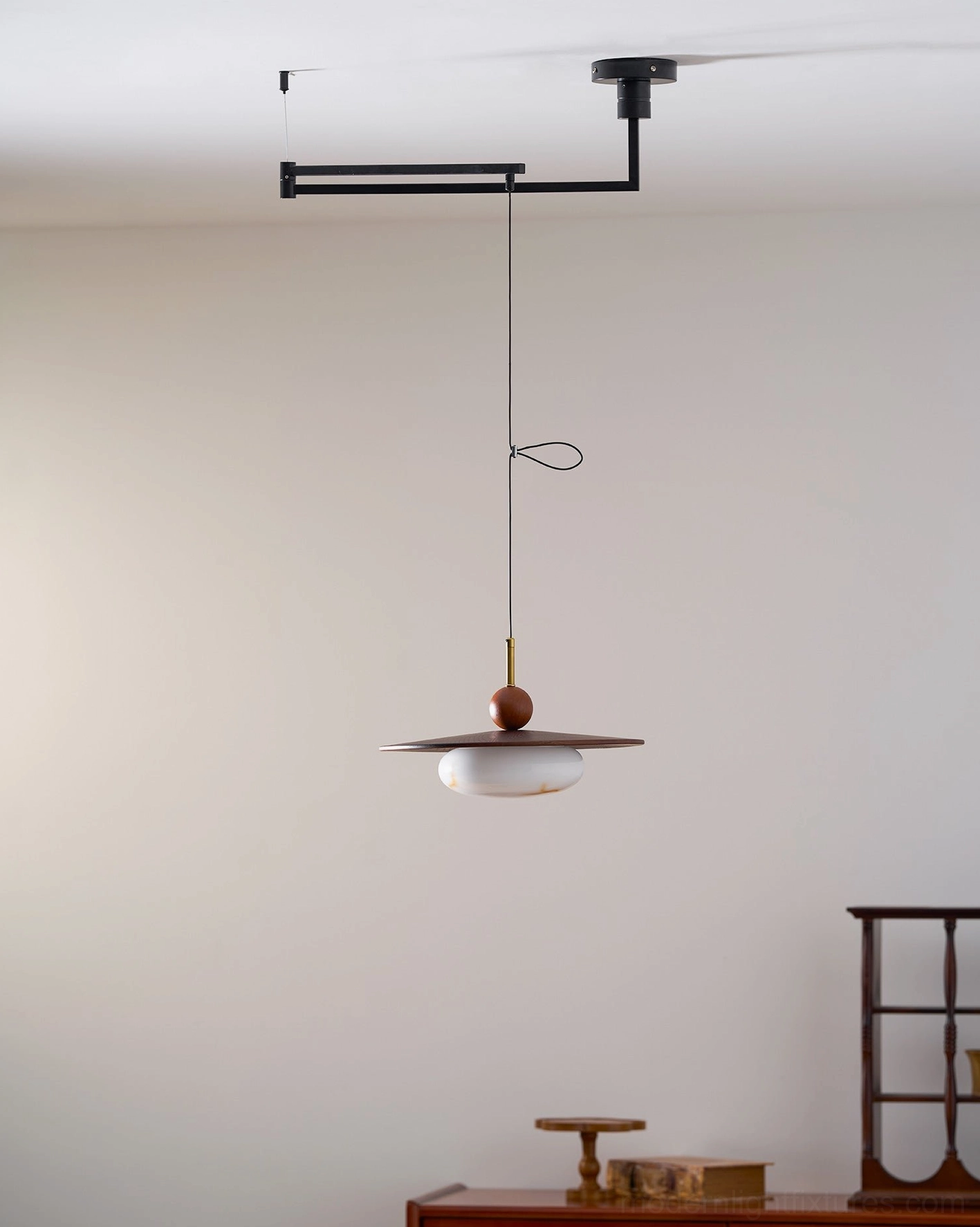 Modern swing arm pendant lamp with wood shade and adjustable articulating black metal frame detail