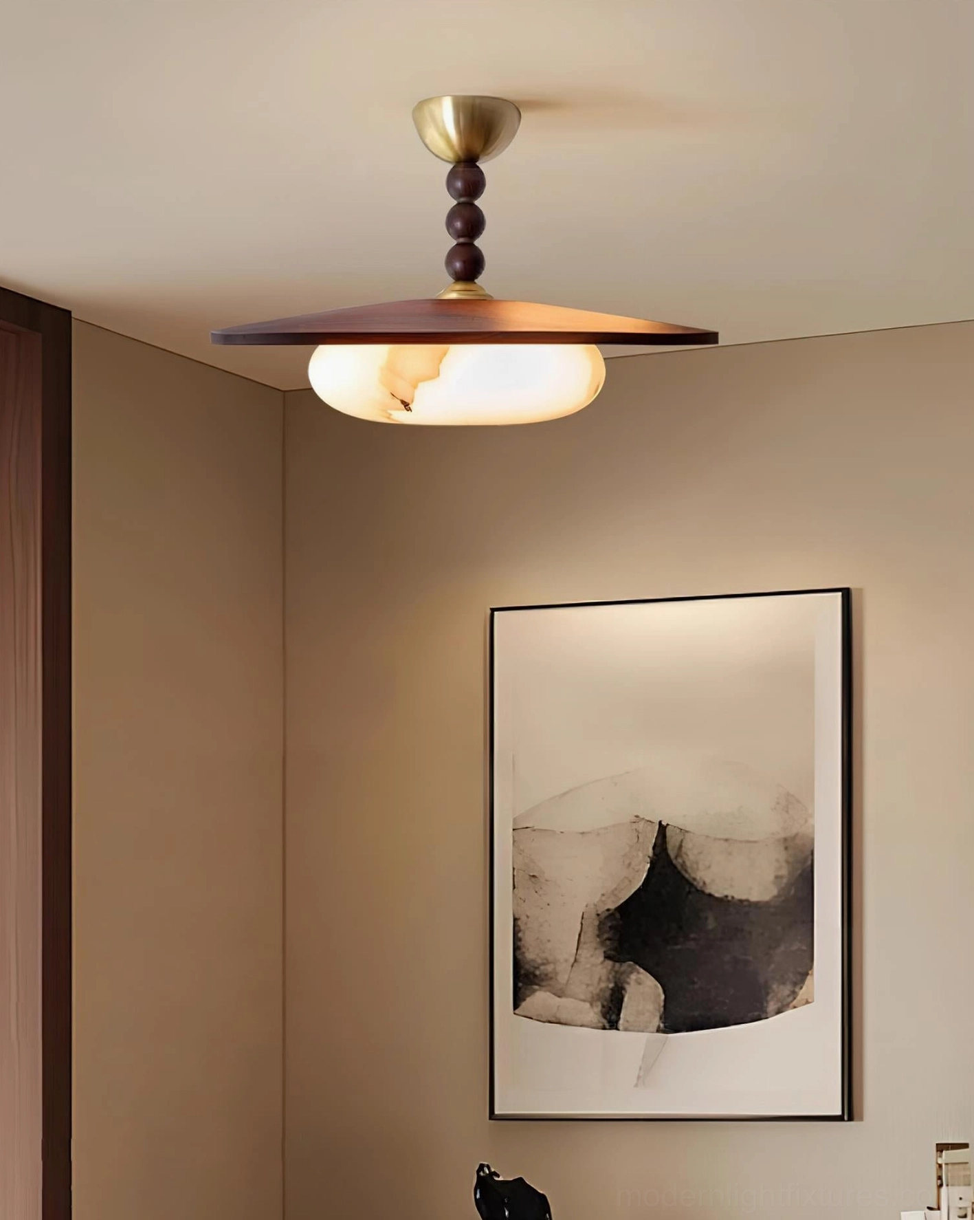 Vicenza damp-rated ceiling light bringing warm glow to bedroom with abstract wall art