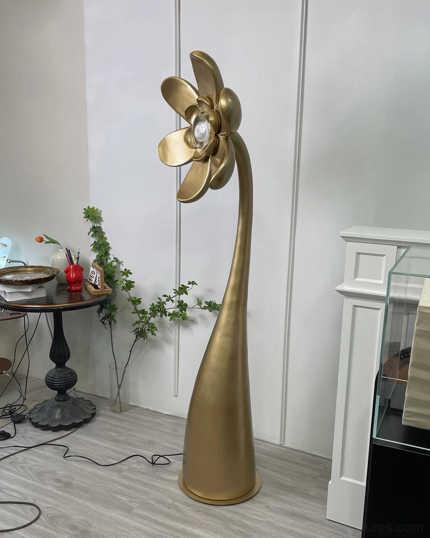 Vicenzio artistic flower floor lamp in gold finish beside round side table - luxury modern home decor