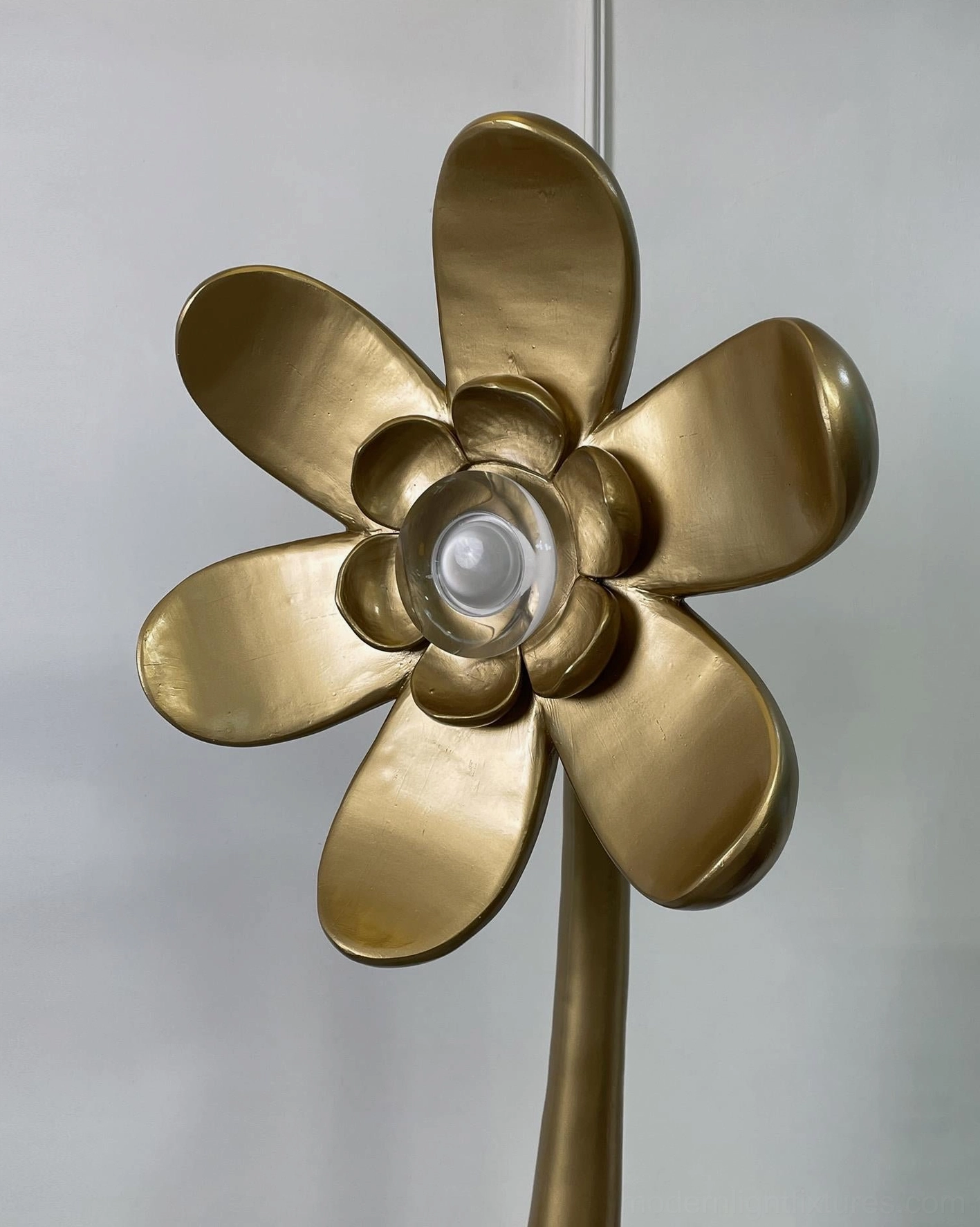 Macro close-up of Vicenzio brushed gold flower lamp petals with exposed central light source