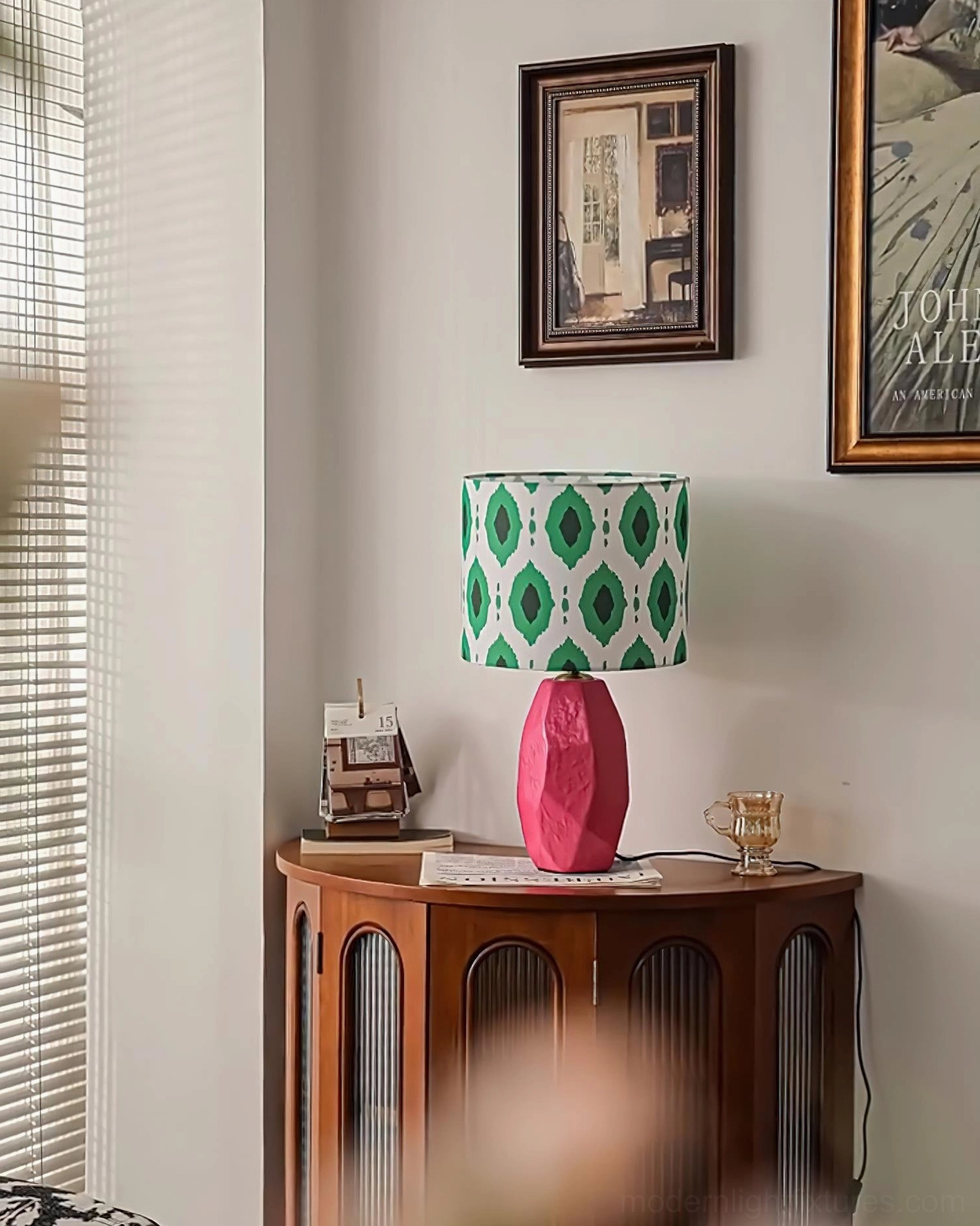 Vico table lamp with white ceramic base and green geometric ikat print shade, studio front view against neutral background