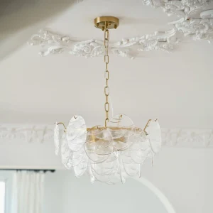 Vintage style glass disc chandelier installed in European retro room with decorative ceiling trim