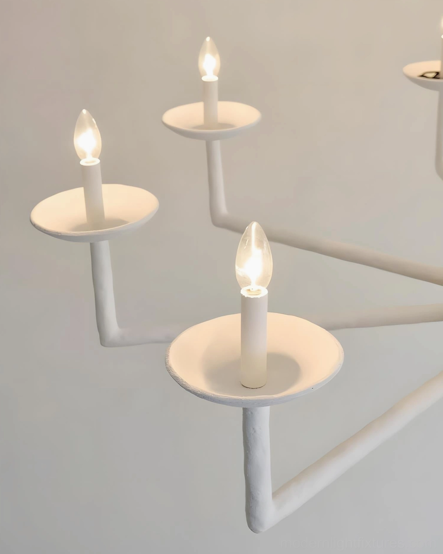 Sculptural vine chandelier installation detail, multi-arm candle-style design closeup