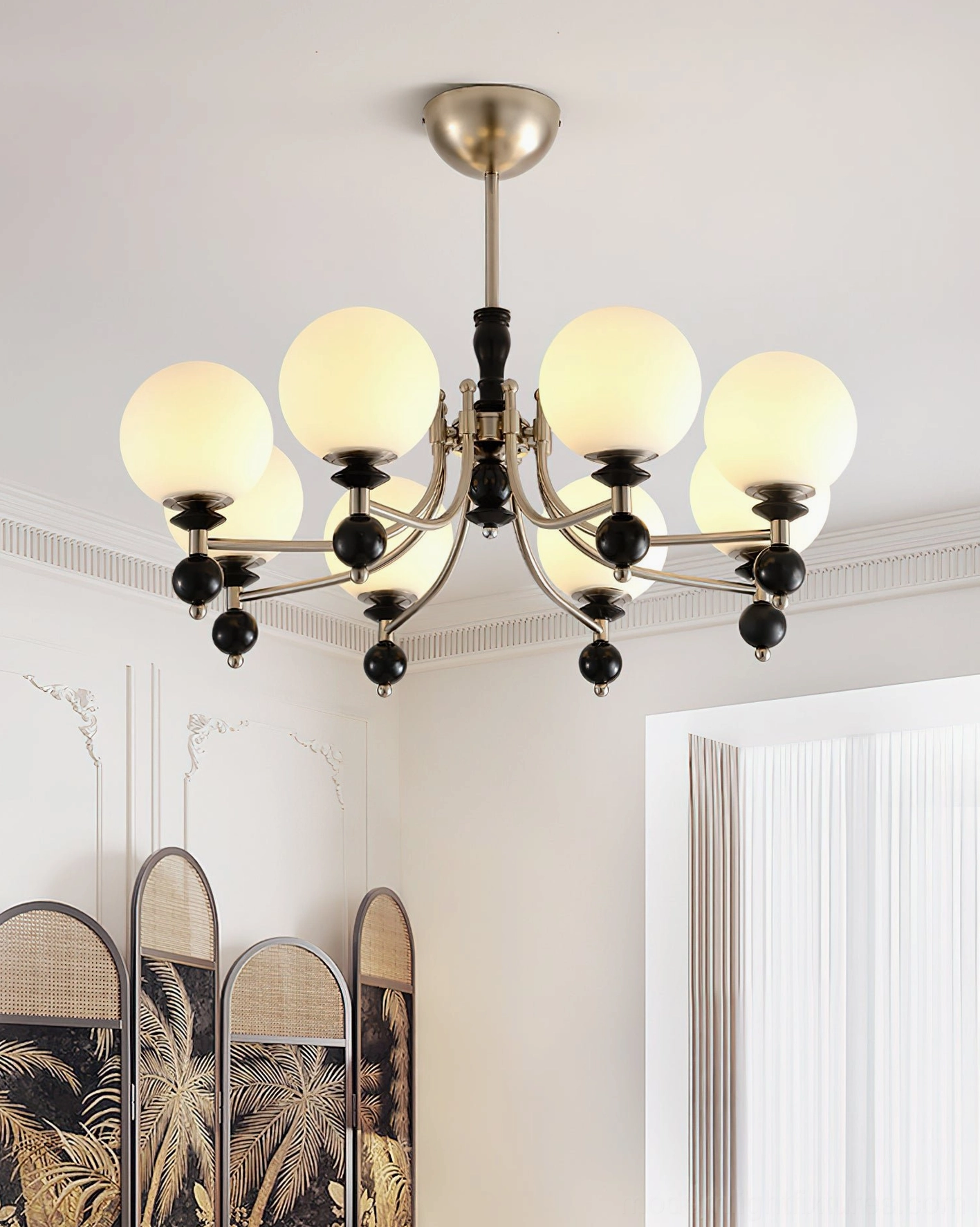 8-head vintage globe chandelier with black metal frame in French country-style living room with decorative screen