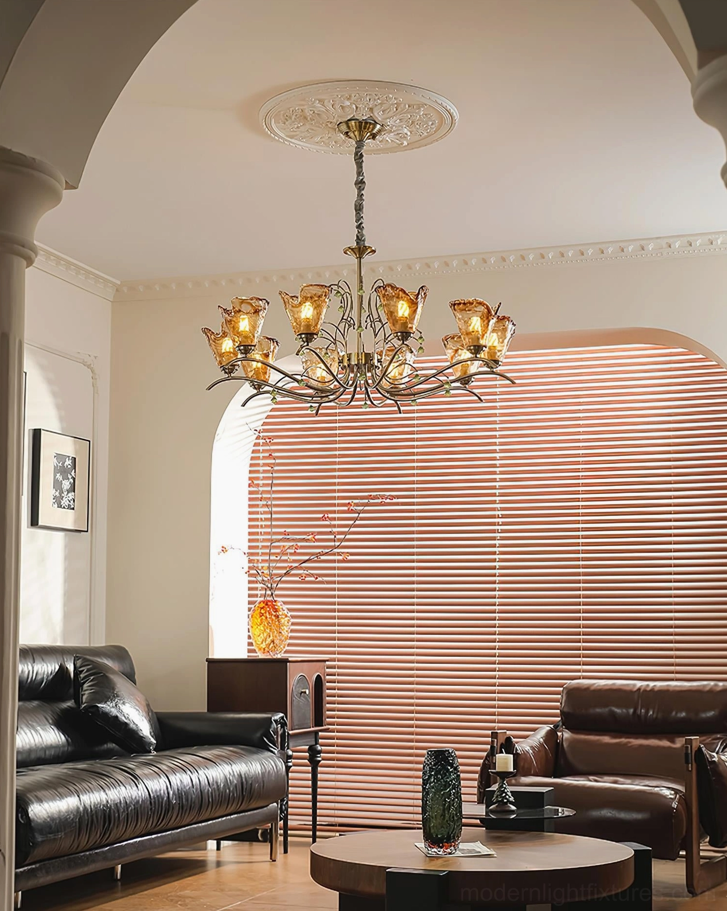 Vetraio glass chandelier displayed in retro vintage living room with black leather furniture, showing full room styling and warm glow