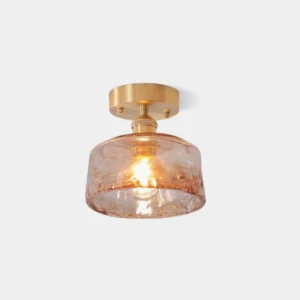 Vintage amber glass semi-flush ceiling light with brushed brass base, studio front view on white background