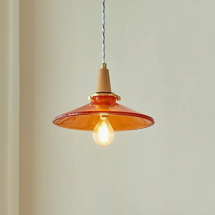 Front close-up of vintage amber glass pendant light showing wide disc shade and exposed Edison filament bulb