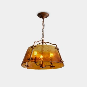 Vintage amber glass pendant light with antique copper frame, front low-angle studio view showing faceted hammered glass texture
