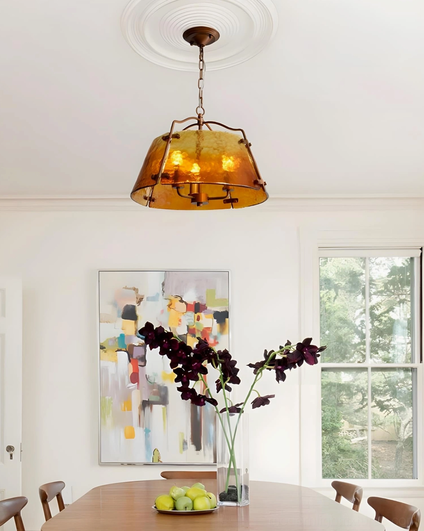 Minimalist warm vintage amber pendant light in residential dining space with contemporary design
