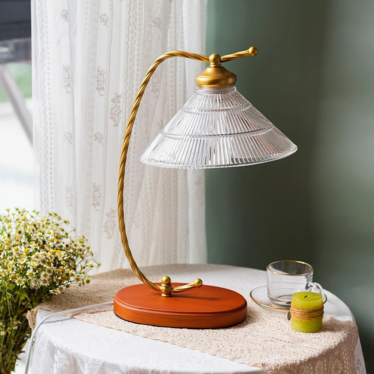 Vintage arc reading table lamp unlit on calm side table with white tablecloth and small candle decor, peaceful bedroom setting