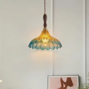 Vintage-inspired azure pendant lamp with embossed glass shade and jewel details in home interior setting