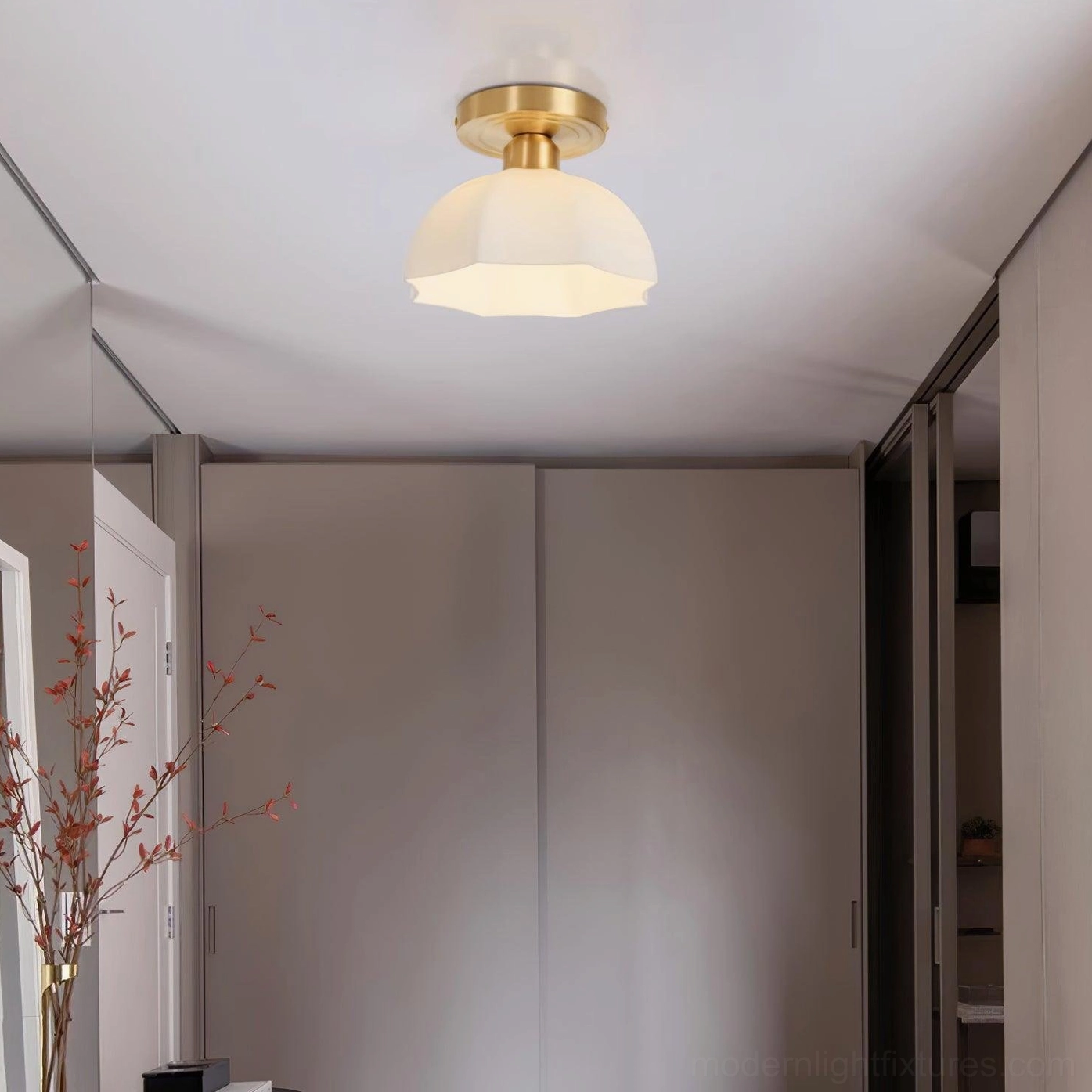 Scalloped ceiling light fixture in luxury vintage bathroom with round vanity mirror and decorative wallpaper