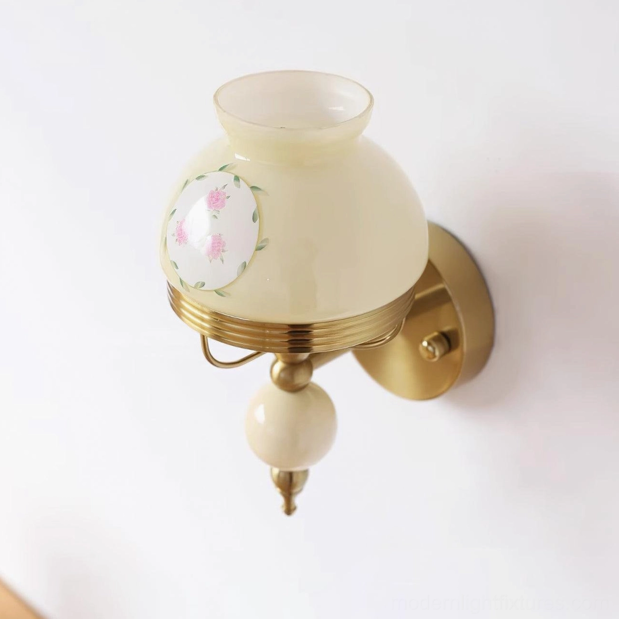 Cream beige floral wall lamp side view with off-white frosted glass shade and brass gold mount
