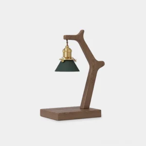 Vintage brass candle warmer lamp with solid wood base and green cone shade, three-quarter front view