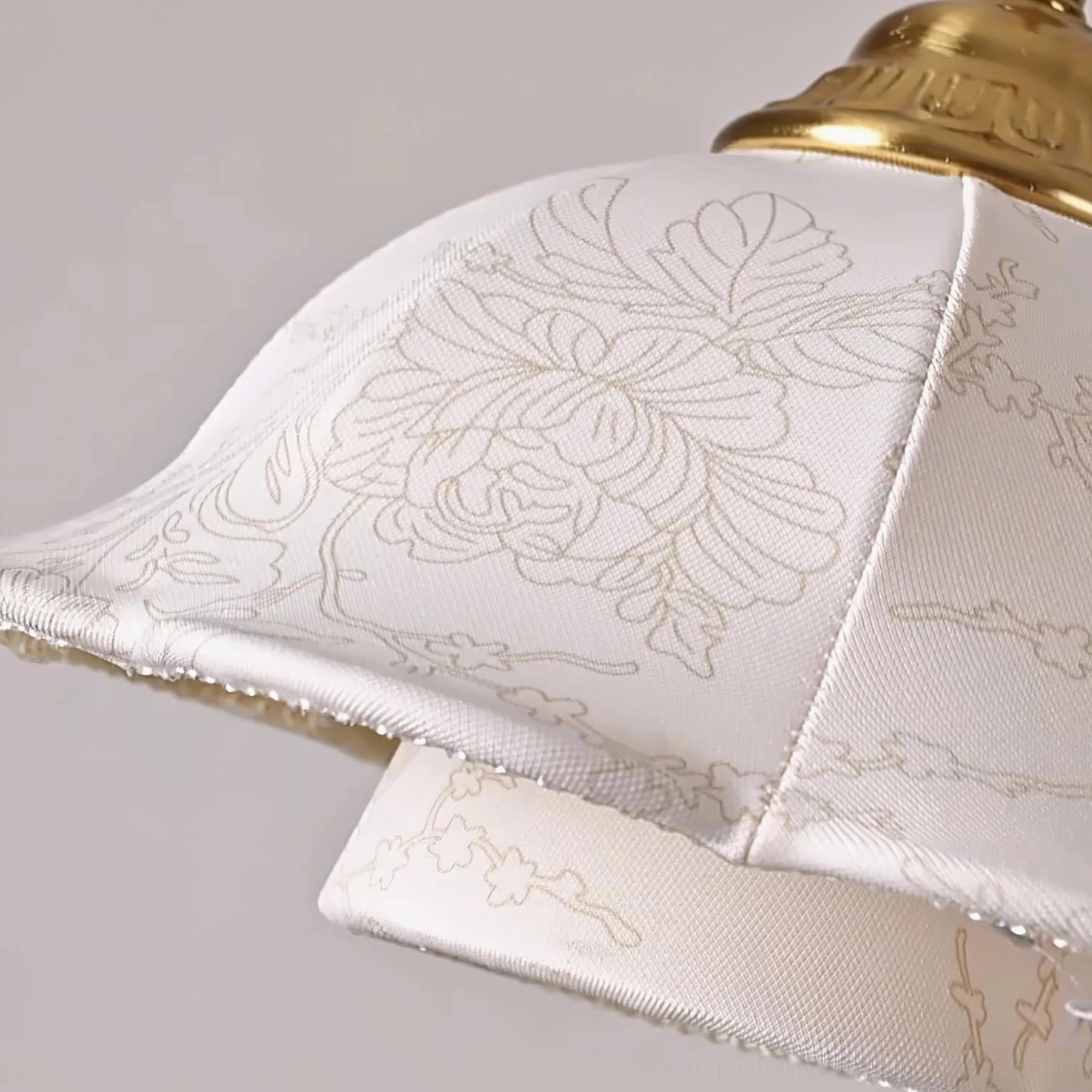 Vintage brass and fabric pendant light with embossed floral shade in home interior environment
